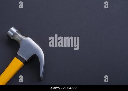 Claw hammer with yellow handle on black background Stock Photo