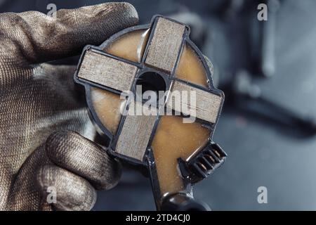 Engine ignition coil in hand of auto mechanic Stock Photo