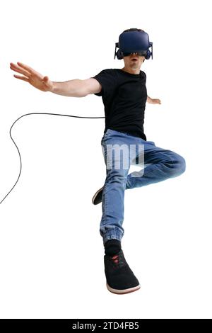 Exited guy using a virtual reality headset isolated on white background. Man looking in VR googgles, inovate intertainment technology Stock Photo