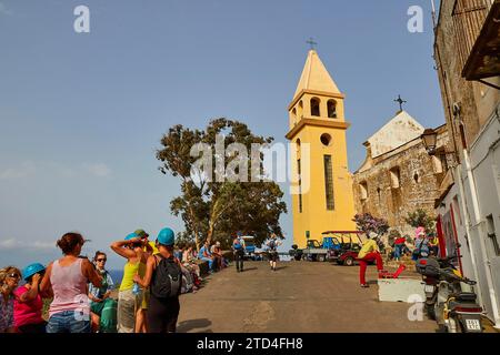 Main town, yellow church tower, hiking group, volcanic island, Stromboli, Aeolian Islands, Lipari Islands, Sicily, Italy Stock Photo