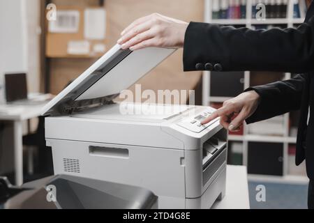 Business woman is using the printer to scanning and printing document Stock Photo