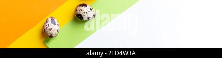 Creative quail egg layout on brown background. Quail eggs pattern. Happy easter concept. Stock Photo