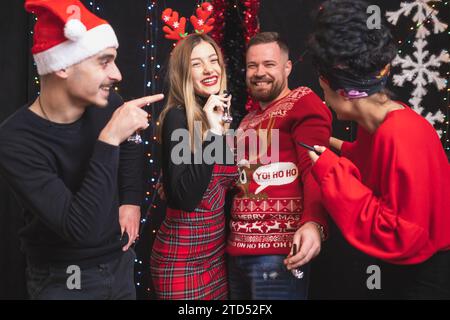 Four friends celebrating New year, having fun Stock Photo