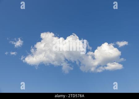Puffy white cumulus clouds float against a deep blue sky, with softly shaded bases and open copy space forming a natural background in Norway. Stock Photo