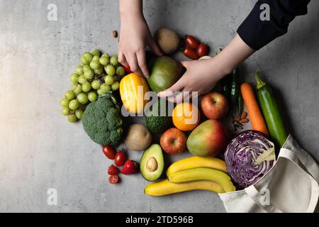 Eco bags, food ingredients, tidying hands Stock Photo