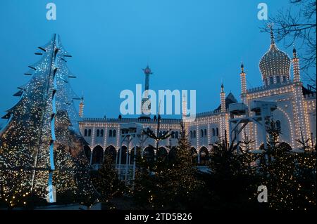 The visiting public watches in fascination at the ever-changing colours of the fairy Christmas lights that decorate the Nimb Hotel and Restaurant within Stock Photo