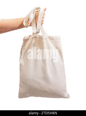 Hand holding tote bag mockup, isolated on white background. Natural shopper Stock Photo