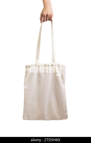 Hand holding tote bag, isolated on white background. Natural cloth shopper Stock Photo
