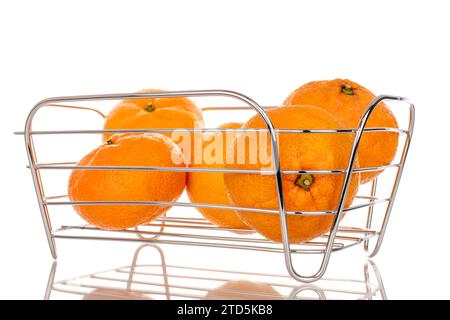 Several juicy sweet tangerines in a basket, macro, isolated on white background. Stock Photo