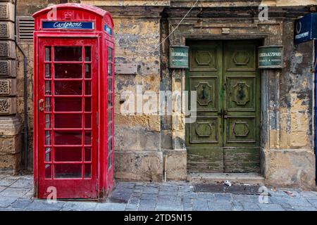 A red British telephone box in the capital of Malta, Valletta, once a part of the British Empire, now a British Protectorate Stock Photo