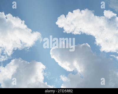 Sunlit white clouds in a summer sky Stock Photo
