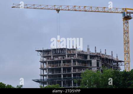 Construction Crane on multi story apartment building construction site Stock Photo