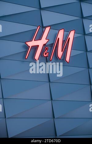 Tallinn, Estonia - December 16, 2023: H and M clothing store light sign. Stock Photo