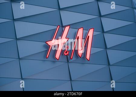 Tallinn, Estonia - December 16, 2023: H and M clothing store light sign. Stock Photo