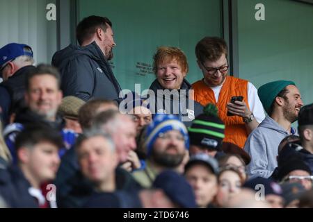 Ipswich, England, UK. 16th Dec, 2023. Ed Sheeran laughs with a friend during the Ipswich Town FC v Norwich City FC sky bet EFL Championship match at Portman Road, Ipswich, England, United Kingdom on 16 December 2023 Credit: Every Second Media/Alamy Live News Stock Photo