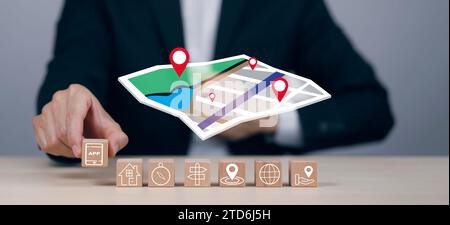 Hand hold wooden block cube and model map with location point , GPS app, icon Travel maps and find places in the online system, all screen graphics ar Stock Photo