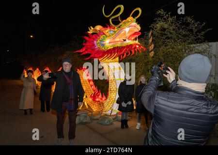 (231217) -- BUDAPEST, Dec. 17, 2023 (Xinhua) -- People take photos at the Year of the Dragon Lantern Festival in Budapest Zoo in Budapest, Hungary, Dec. 16, 2023. A lantern festival opened in Budapest on Saturday as part of the celebrations for the upcoming Chinese Lunar New Year, the Year of the Dragon. The festival showcases hundreds of heritage lantern art pieces from Zigong, a city in southwest China's Sichuan Province known for this traditional art form. (Photo by Attila Volgyi/Xinhua) Stock Photo