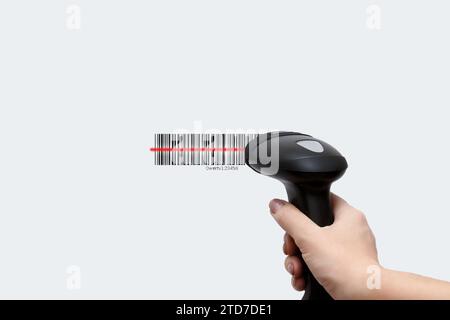 Scanning a barcode using a hand-held scanner. Image of a scanner in a hand on a light background Stock Photo