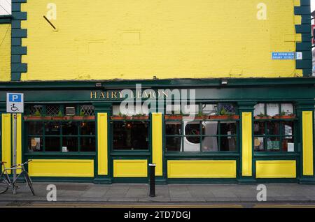 Dublin pub in building with brick painted lemon yellow Stock Photo