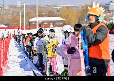 QINGZHOU, CHINA - DECEMBER 17, 2023 - Tourists ride the "magic carpet" to prepare for skiing at the Tuoshan ski Resort in Qingzhou city, East China's Stock Photo