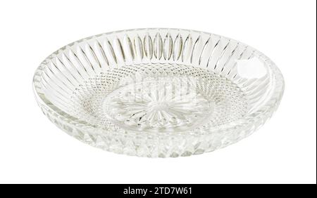 Empty cut glass saucer cutout. Beautiful vintage glass dessert plate isolated on a white background. Glass tableware for food design. Modern crockery Stock Photo