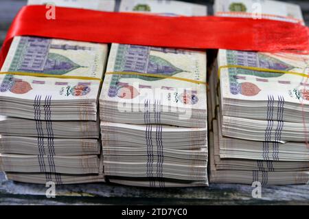 Piles and Stacks of Egypt money  thousands of Pounds currency banknotes bills of 200 EGP LE wrapped with red ribbon, Egyptian money exchange rate and Stock Photo