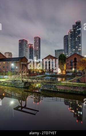 Historic Castlefield in Manchester at night with the modern skyline in the back Stock Photo