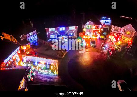 Poole, Dorset, UK.  16th December 2023.  One of Britain’s most festive streets at Runton Road in Poole, Dorset, where most of the houses are decorated in colourful Christmas lights to raise money for charity. The illuminated Christmas displays have been organised by the residents for approximately twenty years and raises funds for local charities from donations made by the many visitors.  Picture Credit: Graham Hunt/Alamy Live News Stock Photo