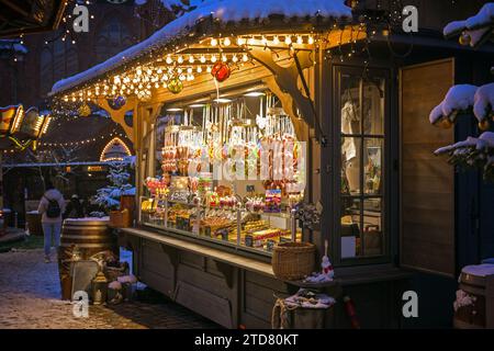 Lubeck, Germany, December 6, 2023: Selling stall with traditional gingerbread hearts and other sweets at the Christmas market in the historic old town Stock Photo