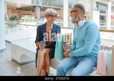 Happy relaxed senior couple spending time at shopping mall Stock Photo
