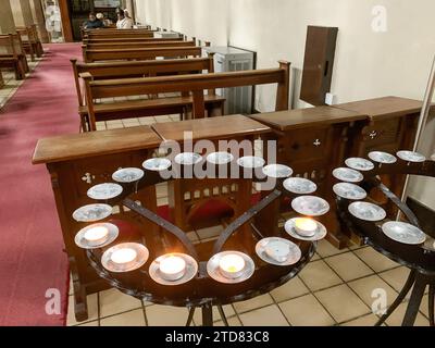 Slough, Berkshire, UK. 16th December, 2023. Candles alight in St Ethelbert's Catholic Church in Slough. Credit: Maureen McLean/Alamy Live News Stock Photo