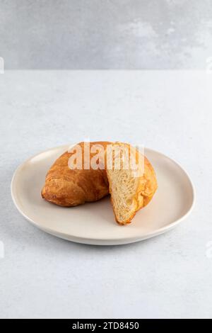 Fresh croissants on a grey background. French breakfast.  Stock Photo