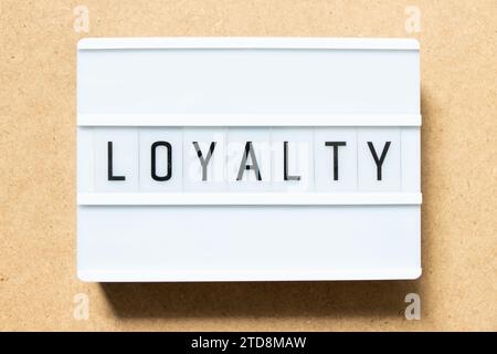 Lightbox with word loyalty on wood background Stock Photo