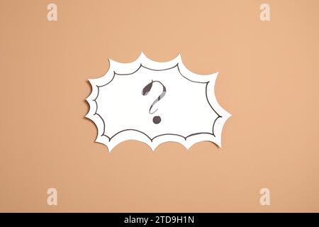 Paper speech bubble with question mark on beige background Stock Photo
