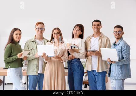 Team of young programmers with gadgets in office Stock Photo