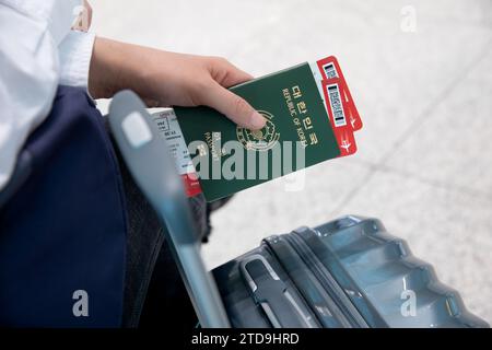 A woman sitting and waiting after completing ticketing at the airport Stock Photo