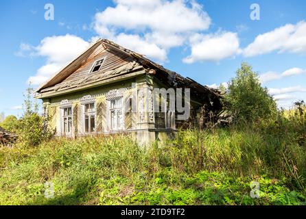 Abandoned destroyed rural wooden house in russian village in summer sunny day. Countryside landscape. The problem of abandoned villages Stock Photo
