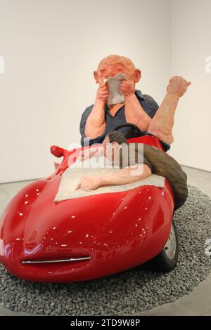 Sculpture of a red car with a man reading a map on the bonnet and driver blowing his nose on display in the Istanbul modern art gallery Stock Photo