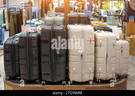 Row black white various sizes suitcases of simple colors on showcase display at an exhibition in a store Stock Photo