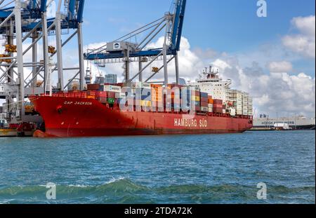 Cap Jackson Hamburg Sud container ship along side cranes at the loading docks in the port city of Auckland, New Zealand Stock Photo