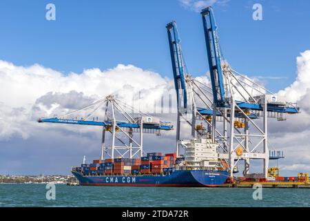 CMA CGM Semarang container ship along side loading dock cranes in the port city of Auckland, New Zealand.  The ship’s registry is Valletta, Malta. Stock Photo