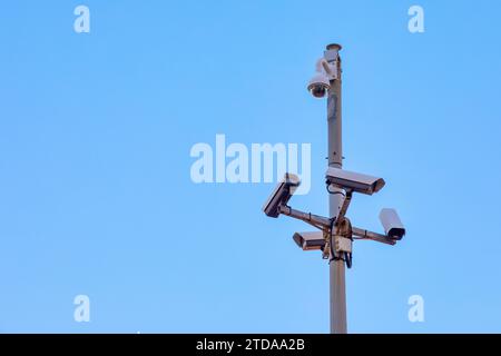 Multiple Surveillance Cameras on Sunny Sky: Ensuring Security and Public Safety Stock Photo