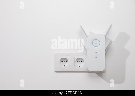 Enhance Your Wifi Range with a Convenient Power Outlet Wifi Extender Stock Photo
