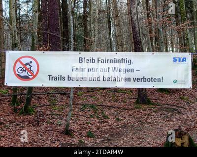 Gauting, Bavaria, Germany. 17th Dec, 2023. Banners hanging at the Gauting mountain bike trails near Munich, Germany. The county of Starnberg recently closed the trails, some of which have been there for two decades, hanging signs confirming the ban, and informing people by the newspapers that police will be patrolling the trails and issuing tickets. Critics reiterate that the trails have been there for decades in some cases and the rules being applied by Bavaria that state all trails must be accessible to foot traffic are archaic and incorrectly applied here. Critics also point out that som Stock Photo