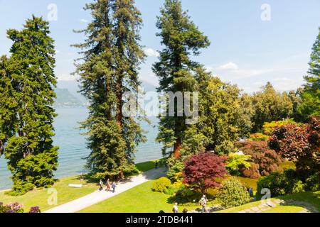 Bellagio Italy - May 8 2011; Group People on paths through gardens on lake edge. Stock Photo