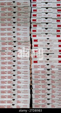 Stack of red and white pizza boxes at a restaurant Stock Photo