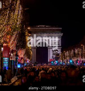 Paris, France - November 19, 2023: The Champs Elysées avenue with christmas decoration and Arc de Triomphe in background in Paris Stock Photo