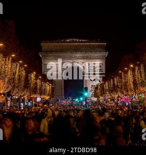 Paris, France - November 19, 2023: The Champs Elysées avenue with christmas decoration and Arc de Triomphe in background in Paris Stock Photo