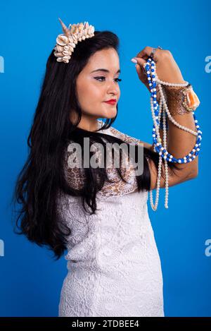 Beautiful Black haired Woman With Shell Tiara On Her Head Holding And Beautiful Black haired Woman With Shell Tiara On Her Head Holding And
