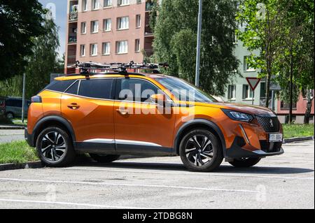 HAVIROV, CZECH REPUBLIC - JULY 27, 2023: Peugeot 2008 crossover parked on the street with orange colour Stock Photo